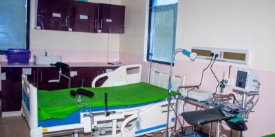 A healthcare professional attending to a mother and baby, representing Maternal & Child Health (MCH) services.