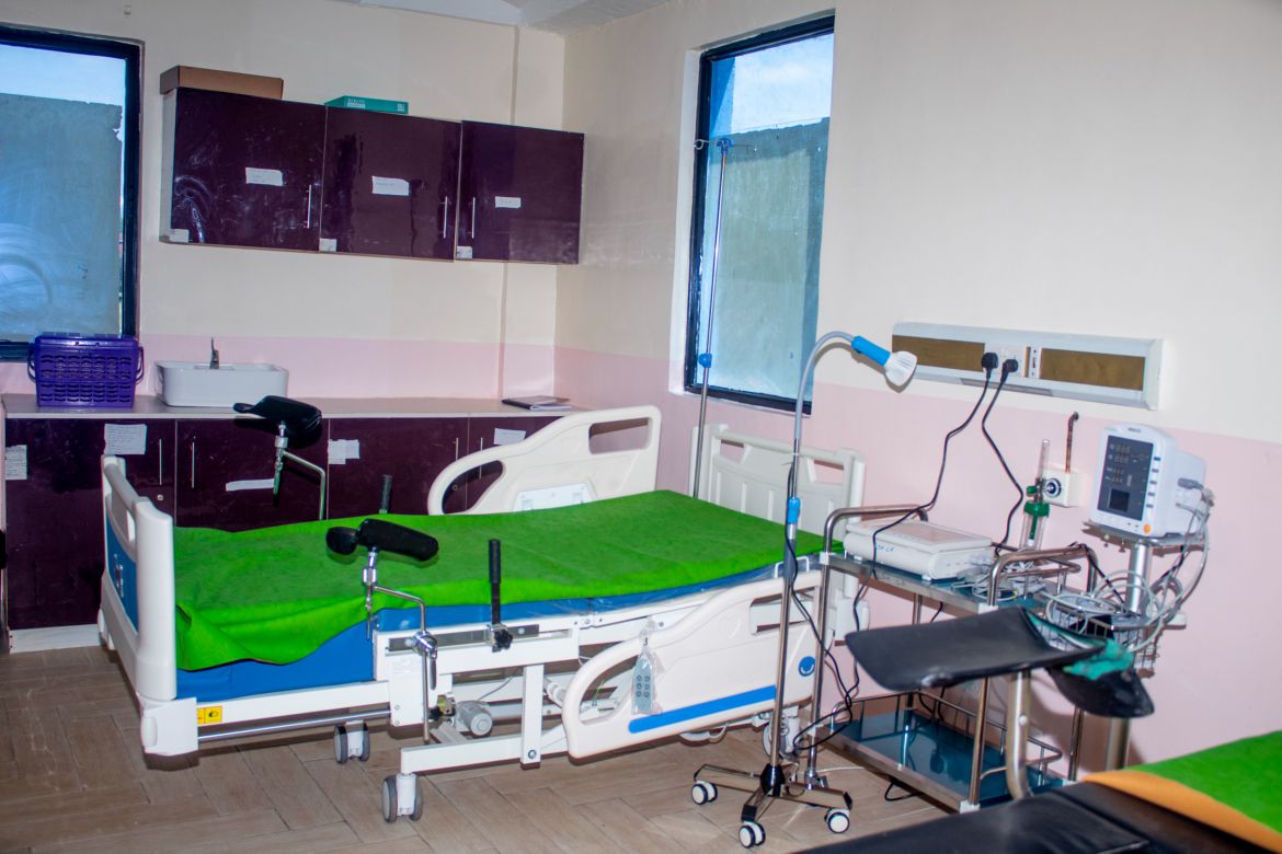 A healthcare professional attending to a mother and baby, representing Maternal & Child Health (MCH) services.